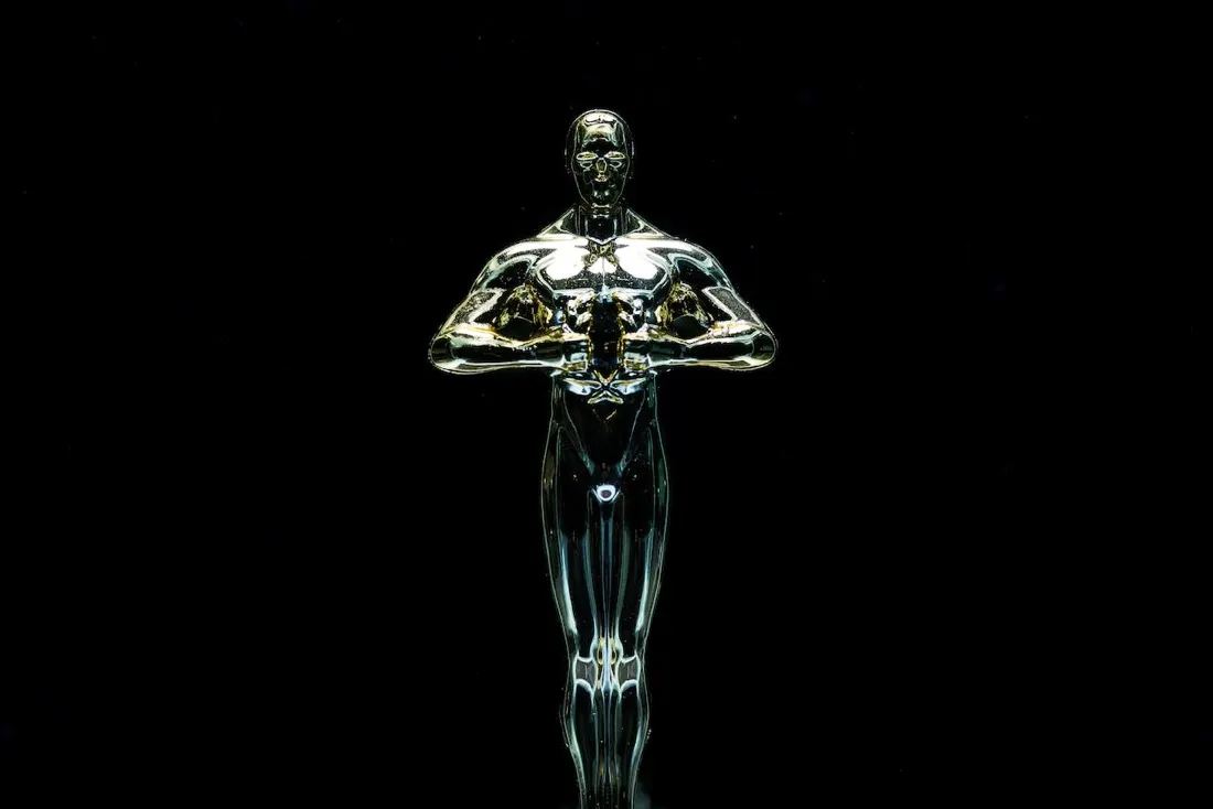 Gold award statuette lit against a black background, for the Global Awards 2024