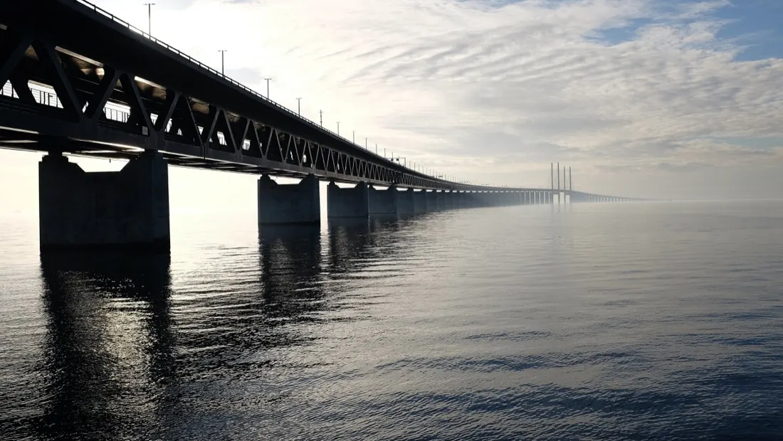 A long bridge stretching into misty water, symbolising bridging the digital divide