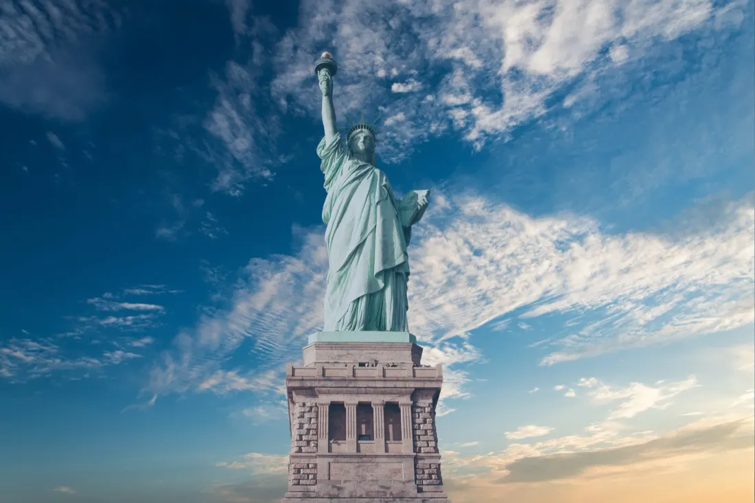The Statue of Liberty against a blue sky, illustrating findings from the USA Wealth Report