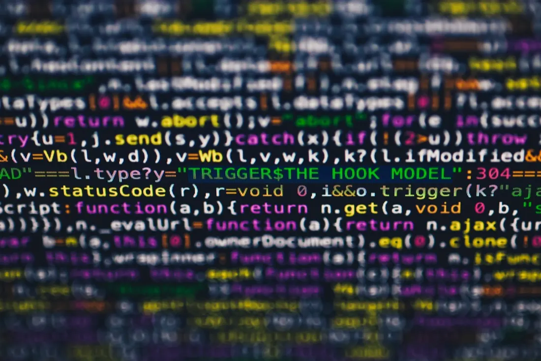Blurred lines of computer code on screen with a highlighted line, representing ransomware attacks