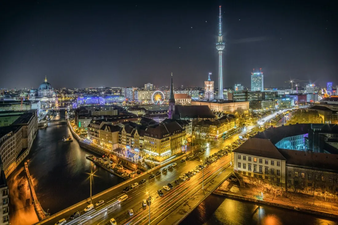 Illuminated German city skyline at night with a television tower, illustrating freelance regulation