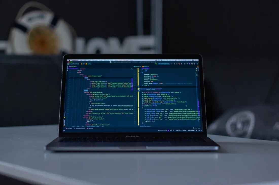 Laptop on a desk displaying lines of code, illustrating a looming IT skills crisis