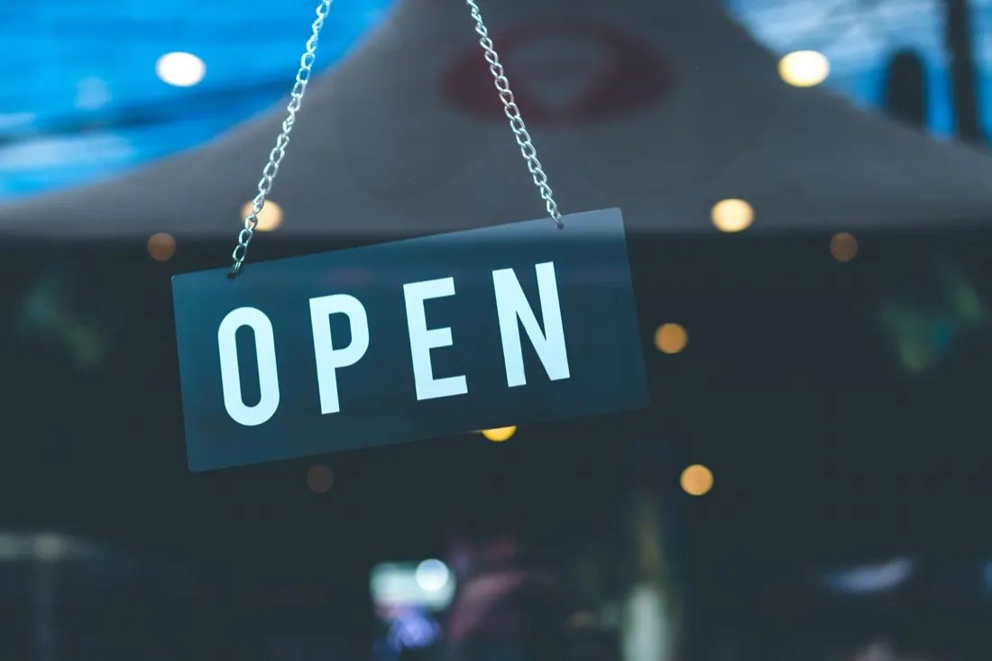 Open sign hanging in a cafe window, illustrating business resilience and recovery during lockdown
