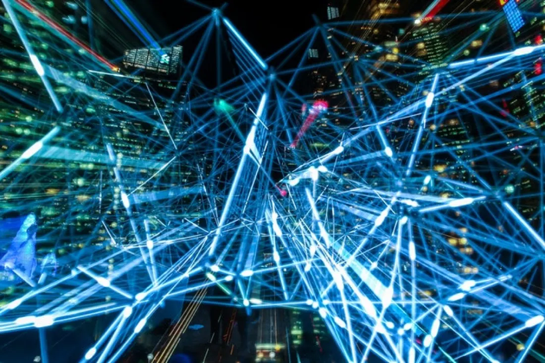 Glowing network lines overlaid on a city skyline at night, symbolising institutional investment