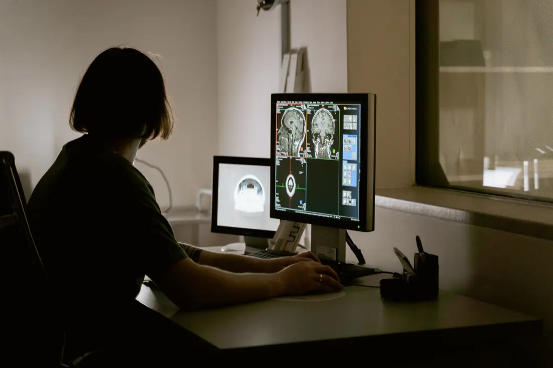 Clinician reviewing brain scan images on monitors, reflecting digitalisation across the global medtech industry